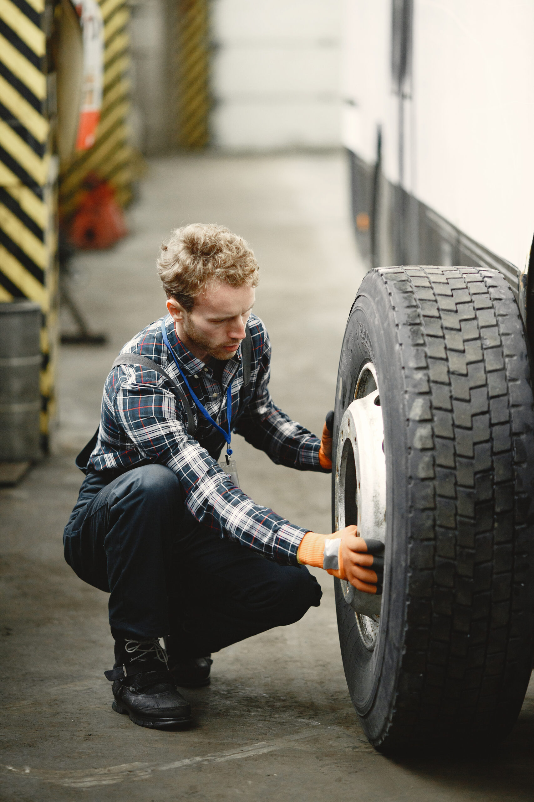 Man checks the wheel for serviceability in garage
